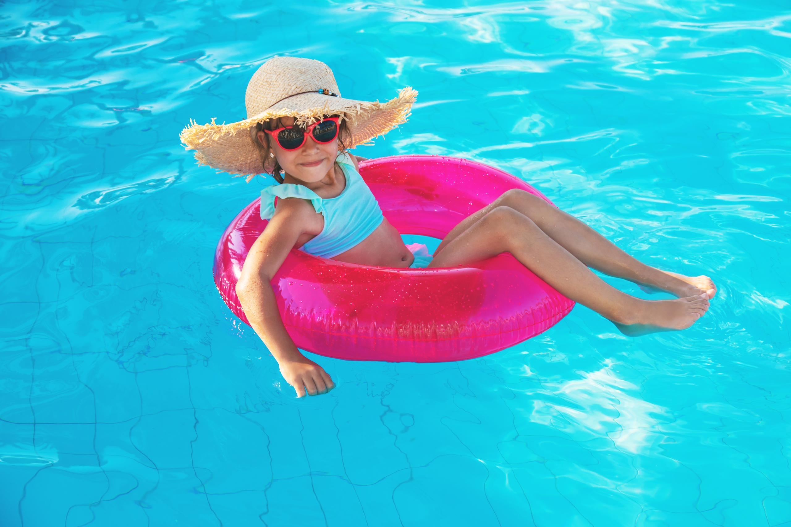 A young girl on a pool float.